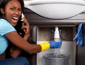 Emergency plumbing repair for a leaking sink drain under a bathroom vanity in Lafayette, LA