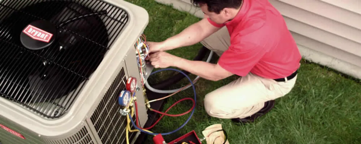 HVAC technician servicing an outdoor air conditioner unit in Lafayette, LA
